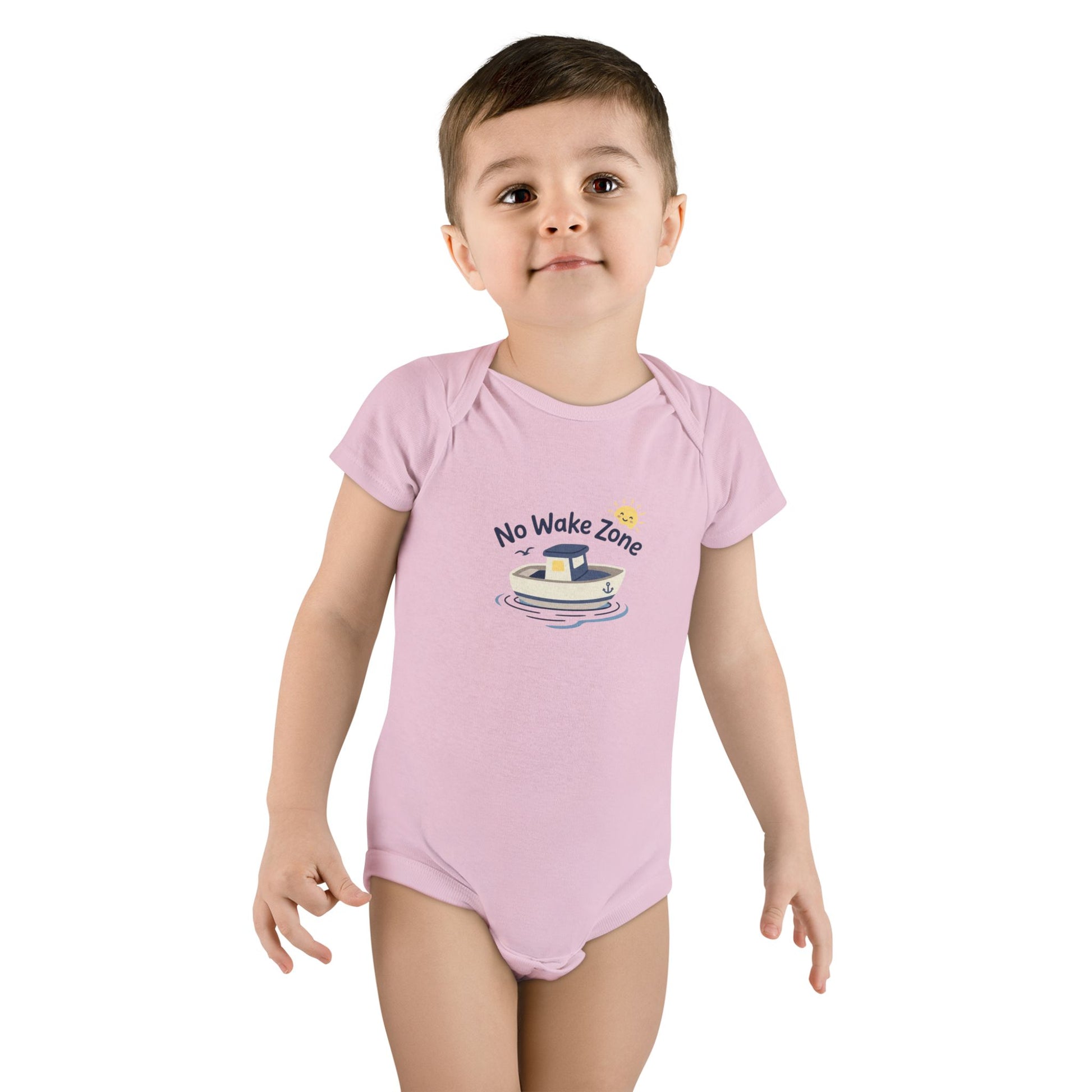 Toddler girl wearing pink No Wake Zone Onesie with nautical boat graphic