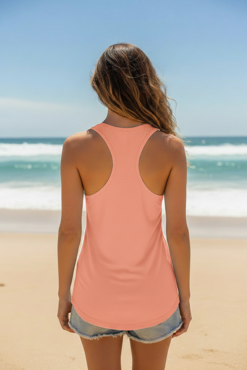 Woman wearing sunset Great South Babe tank top, back view on the beach